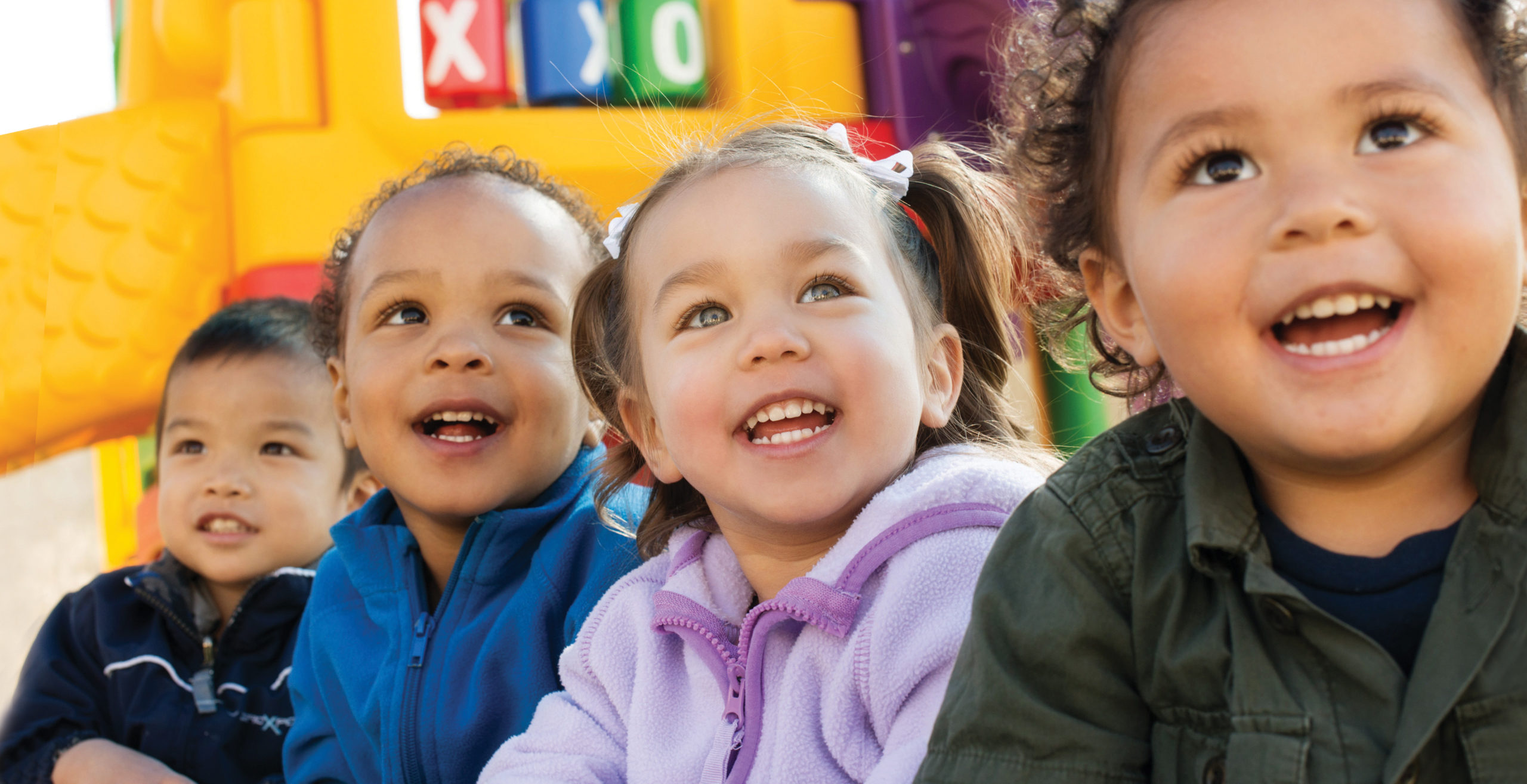 Four happy preschool age children