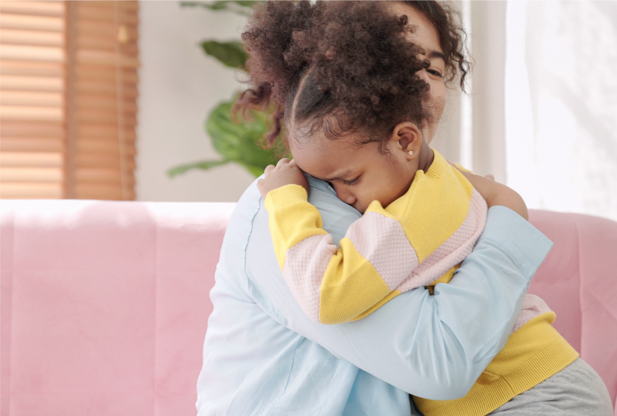 Young girl getting a hug from her mother