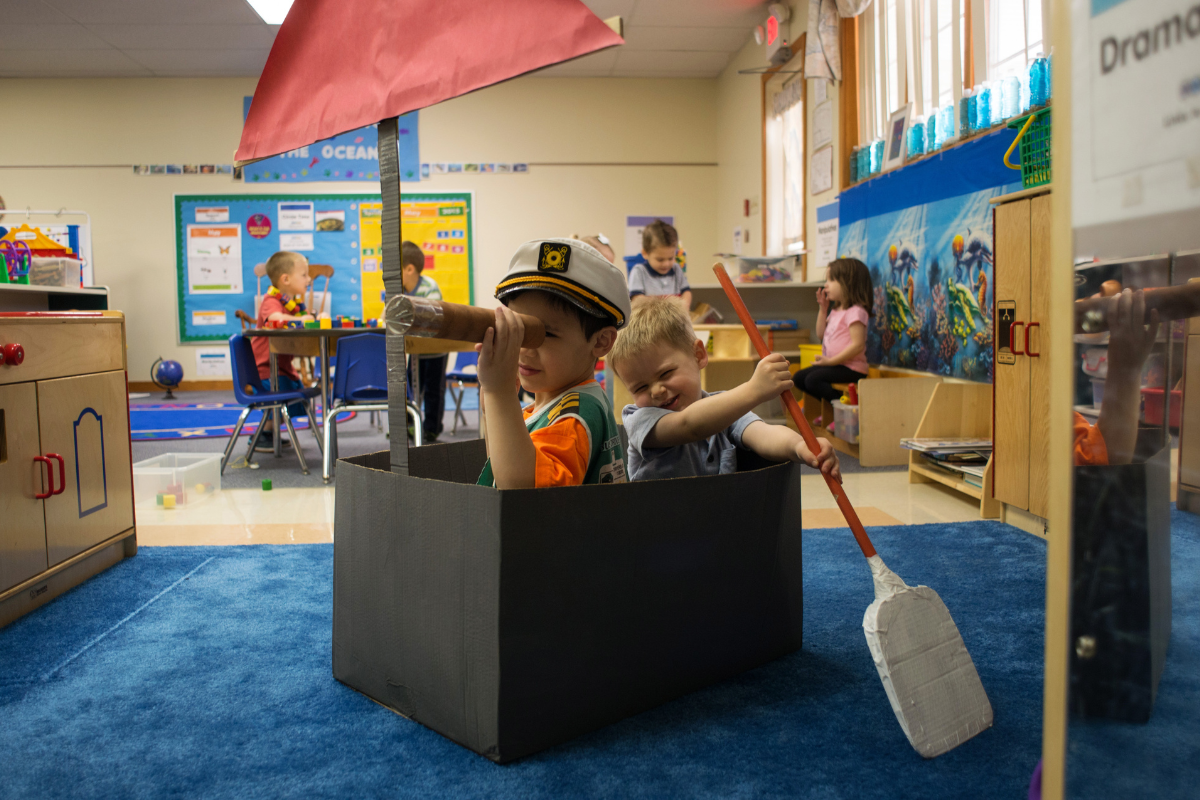 Two boys at daycare participating in dramatic play